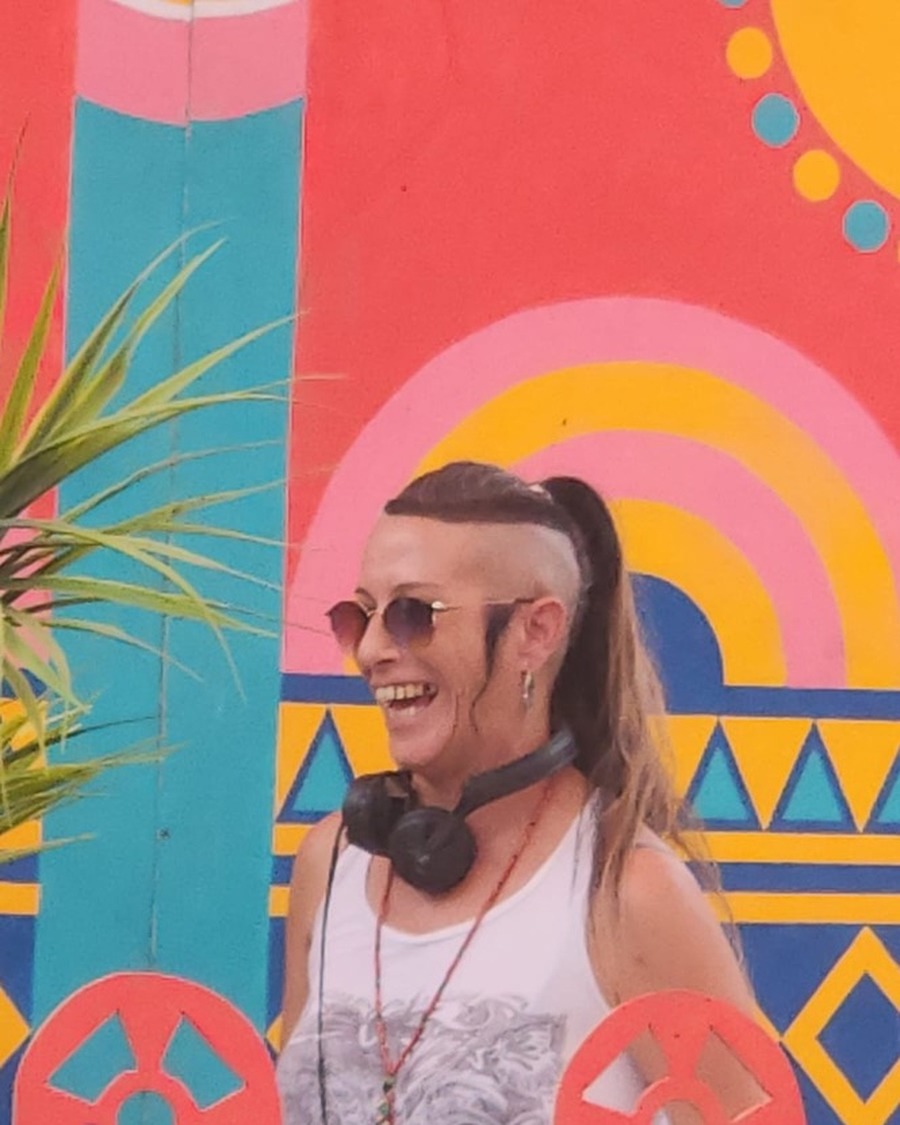 Gula K laughing, colorful mural backdrop